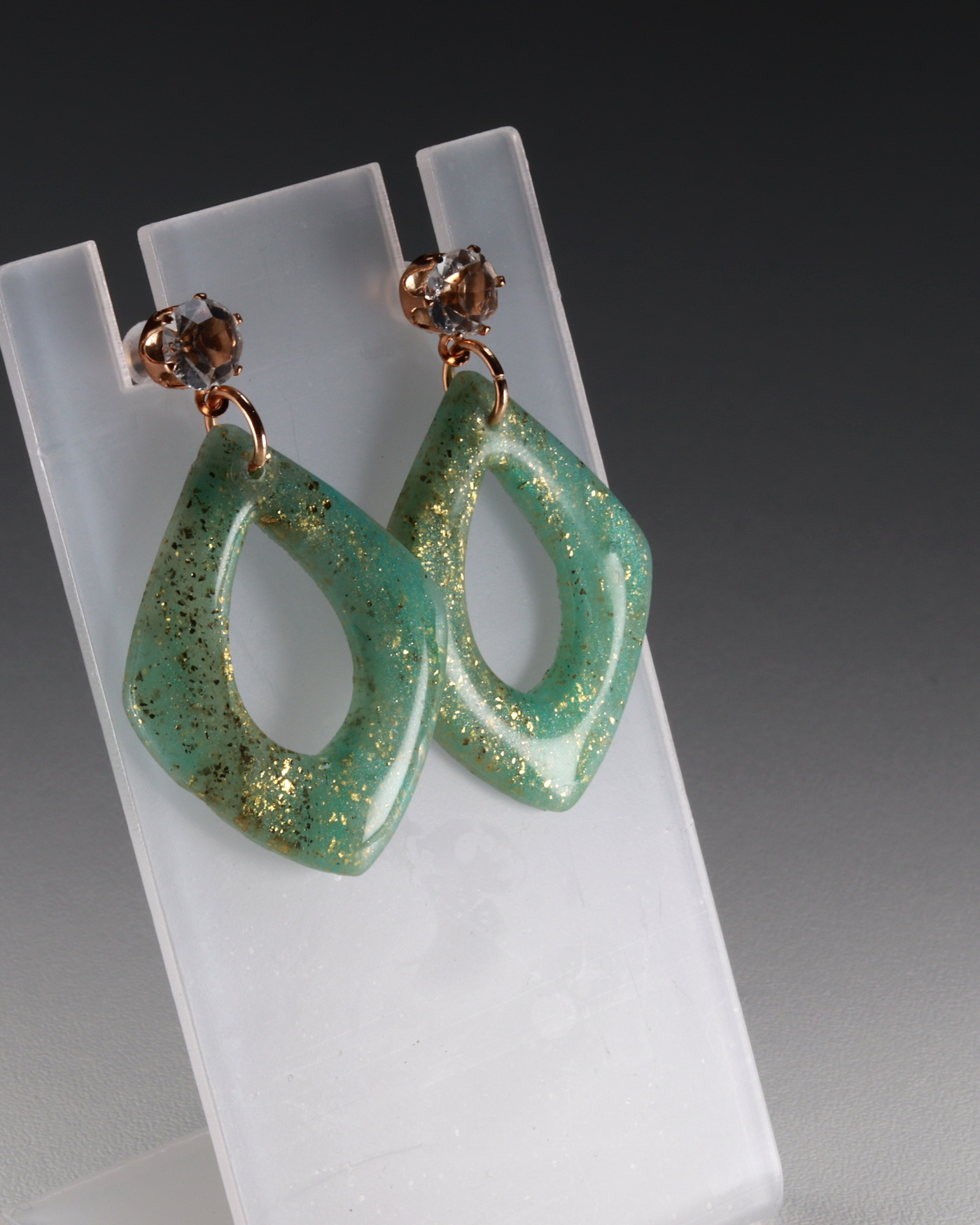 Turquoise marbled earrings in a tall editorial crop