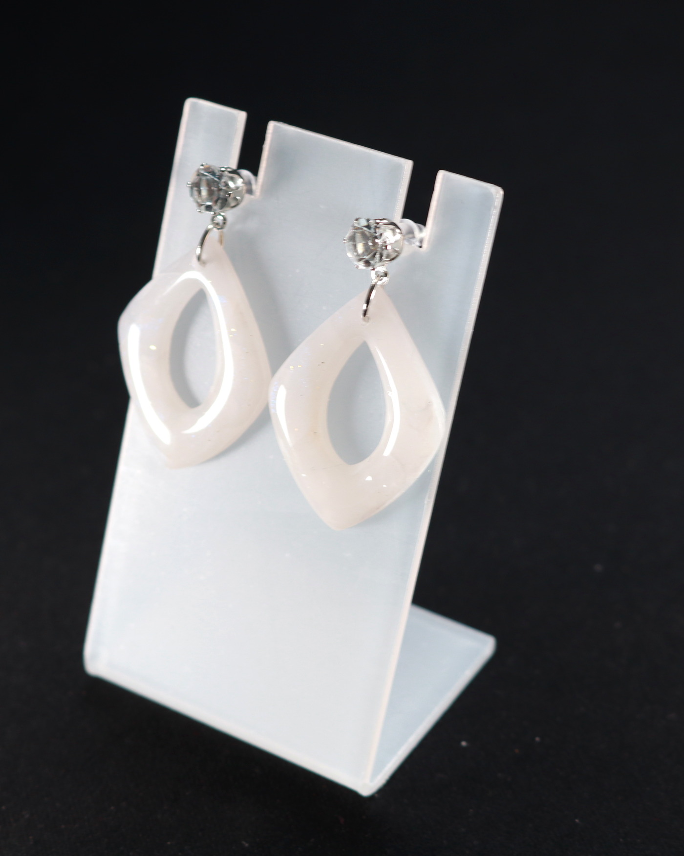 Ivory sculptural earrings in a detail crop