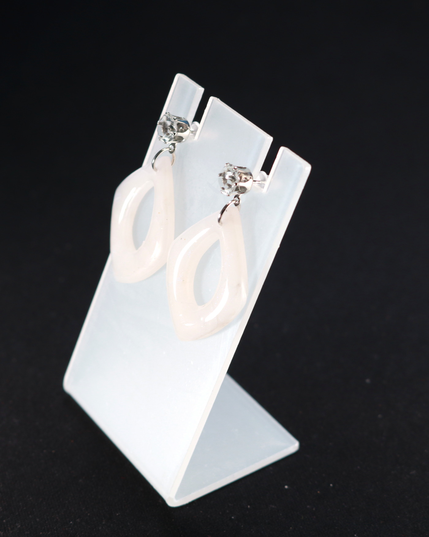 Ivory sculptural earrings shown as a paired composition