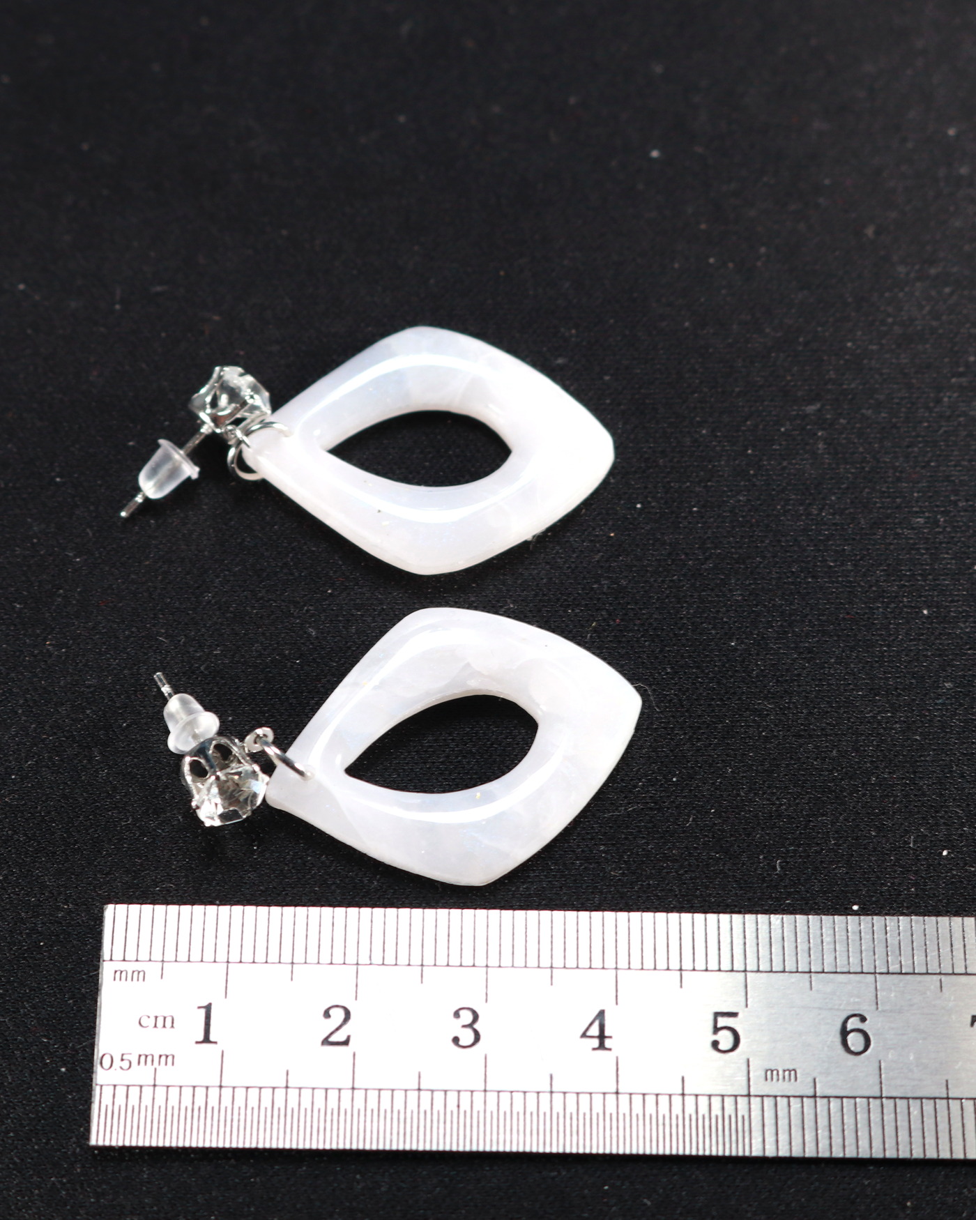 Ivory sculptural earrings in the final reveal frame