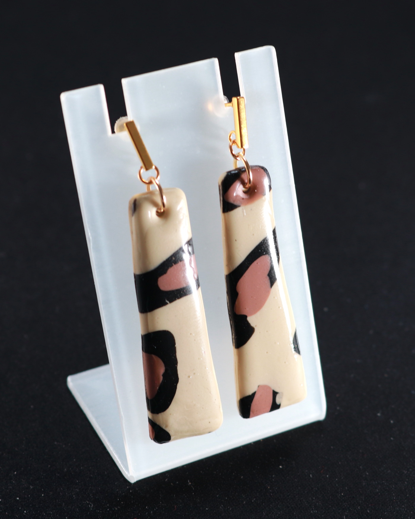 Leopard statement earrings in an opening editorial crop