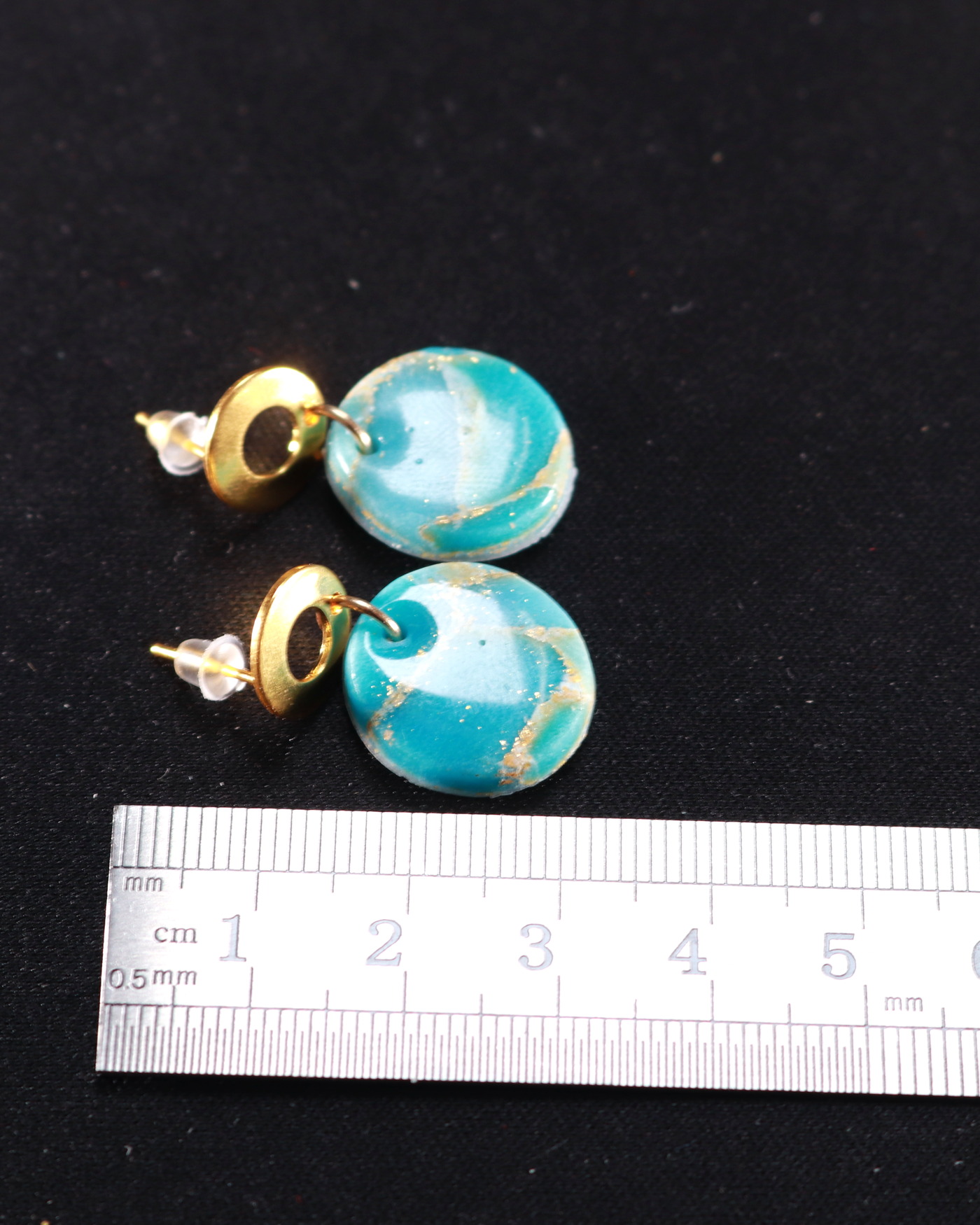 Turquoise marbled earrings in a luxe opening composition